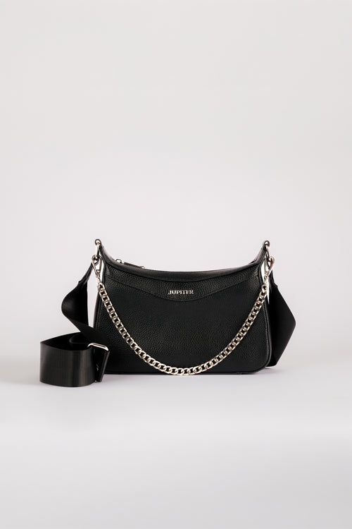 A black leather crescent-shaped shoulder bag with a silver-tone chain strap and a matching black leather strap accessory, displayed on a light gray background. Branded with the name Jupiter. Safety features included to keep passport, money and other valuables safe when travelling overseas or on holiday