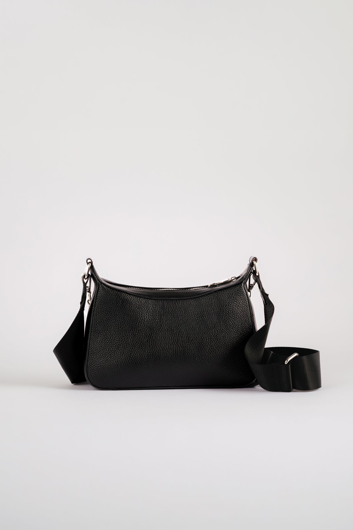 A black leather shoulder travel bag with a matching detachable shoulder strap, displayed against a clean, light gray studio background. Safety features are included in this bag for protection of valuables when travelling on holidays
