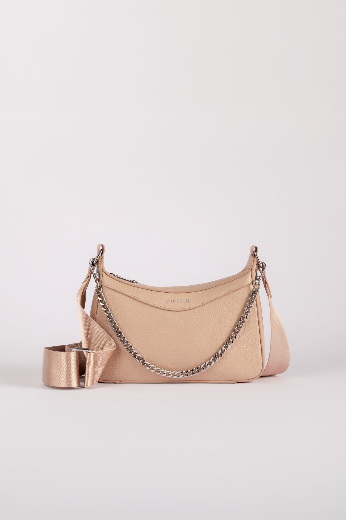 A light beige leather shoulder travel bag with a silver chain strap and a matching wide silver belt, shown on a light gray background. The handbag comes with safety features such as anti theft zipper, slash proof material and RFID protection.