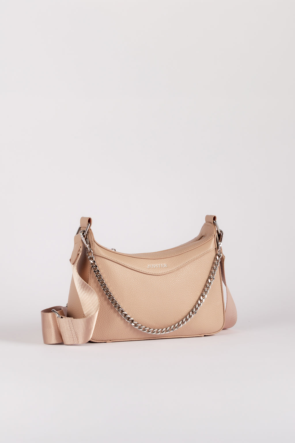 A light beige Jupiter leather shoulder bag with a silver chain strap and a matching wide fabric shoulder strap, set against a plain light gray background. The handbag comes with safety features such as anti theft zipper, slash proof material and RFID protection.