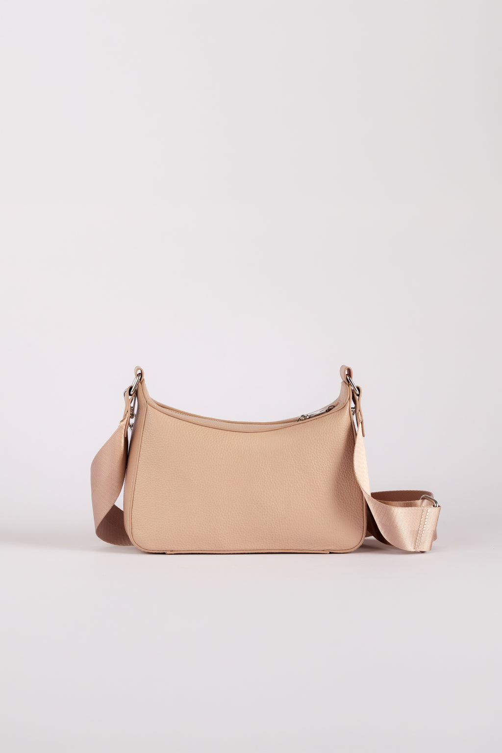 A small shoulder travel bag branded Jupiter in a beige color, featuring a matching detachable strap and a zippered pouch attachment, set against a plain light gray studio background. The handbag comes with safety features such as anti theft zipper, slash proof material and RFID protection.